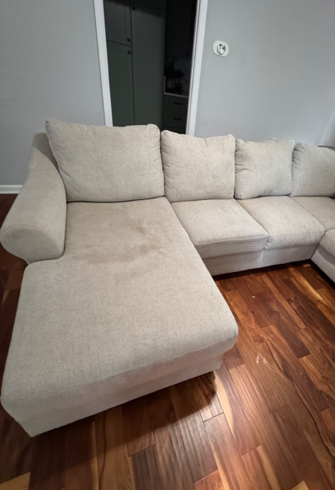 Sectional sofa with visible stains before GraceWell cleaning